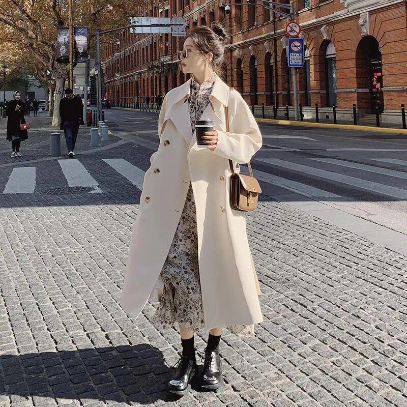 รูปภาพ:https://ae01.alicdn.com/kf/S21f7688493304e529cd52a9c5c88cfc3F/Women-s-White-Fashion-Trench-Coat-Long-Model-Spring-Autumn-2023-New-Korean-Version-Casual-Loose.jpg