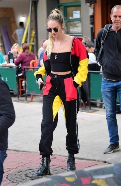 รูปภาพ:https://i.styleoholic.com/2018/05/With-red-yellow-and-black-bomber-jacket-joggers-and-lace-up-boots.jpg