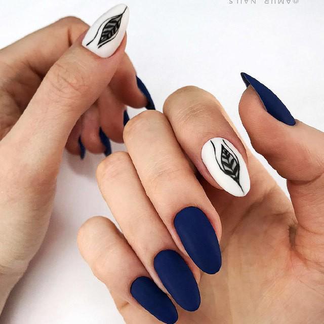 รูปภาพ:http://glaminati.com/wp-content/uploads/2018/03/almond-shaped-nails-long-navy-blue-white-matte-black-leave-accent-design.jpg